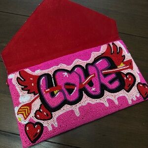 Never used, gorgeous beaded clutch. Playful unique accessory to your outfit.